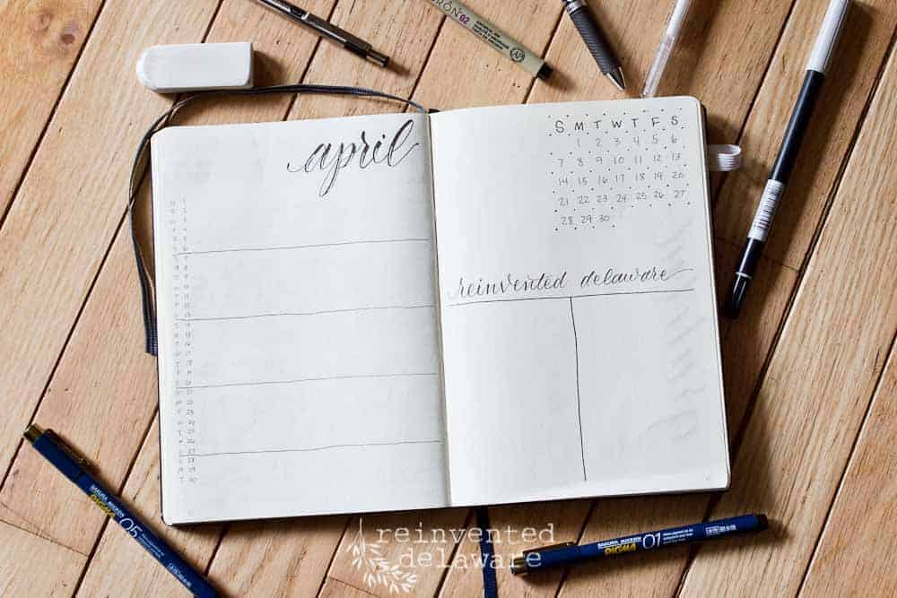 bullet journal showing monthly layout with pens