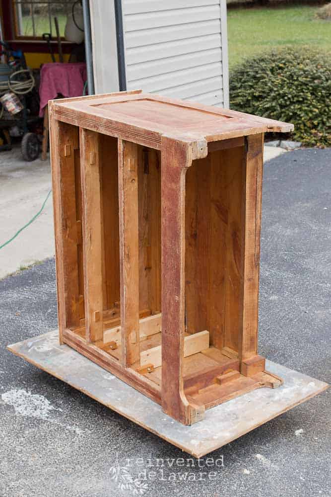 antique dresser on it's side after sanding and cleaning