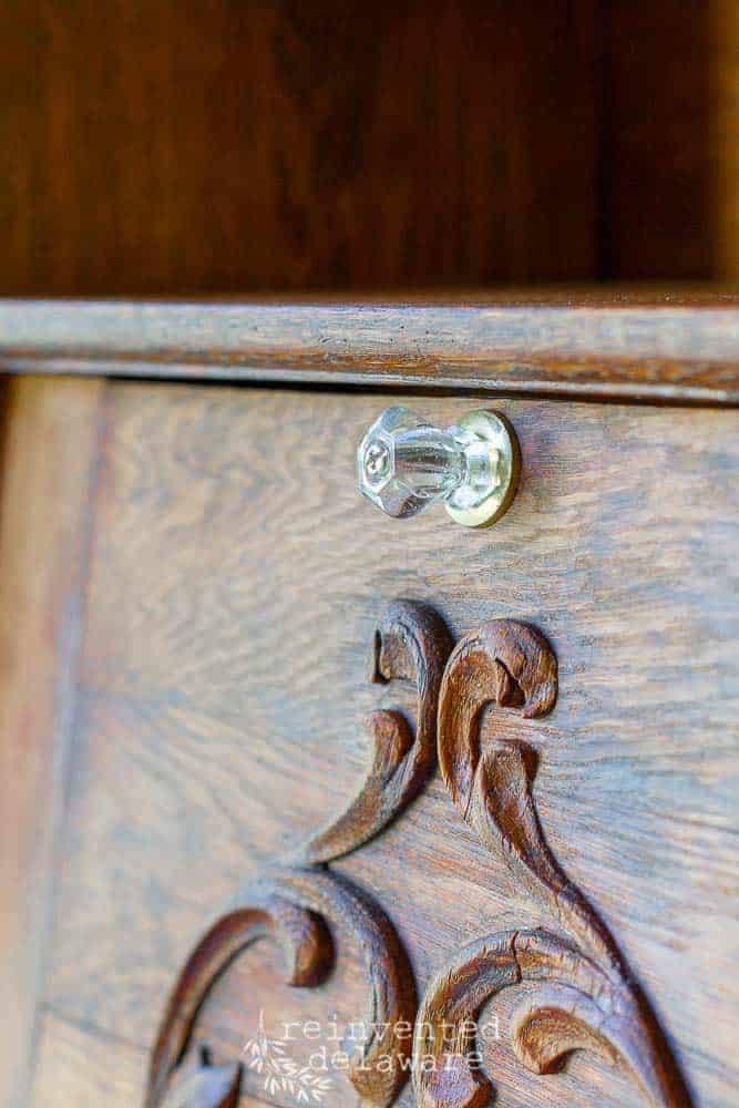 restored vintage side by side secretary desk detail of glass knob and wood carved detail
