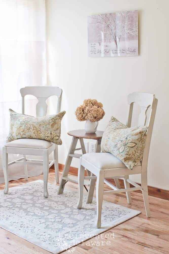 two chairs staged with upcycled step ladder side table