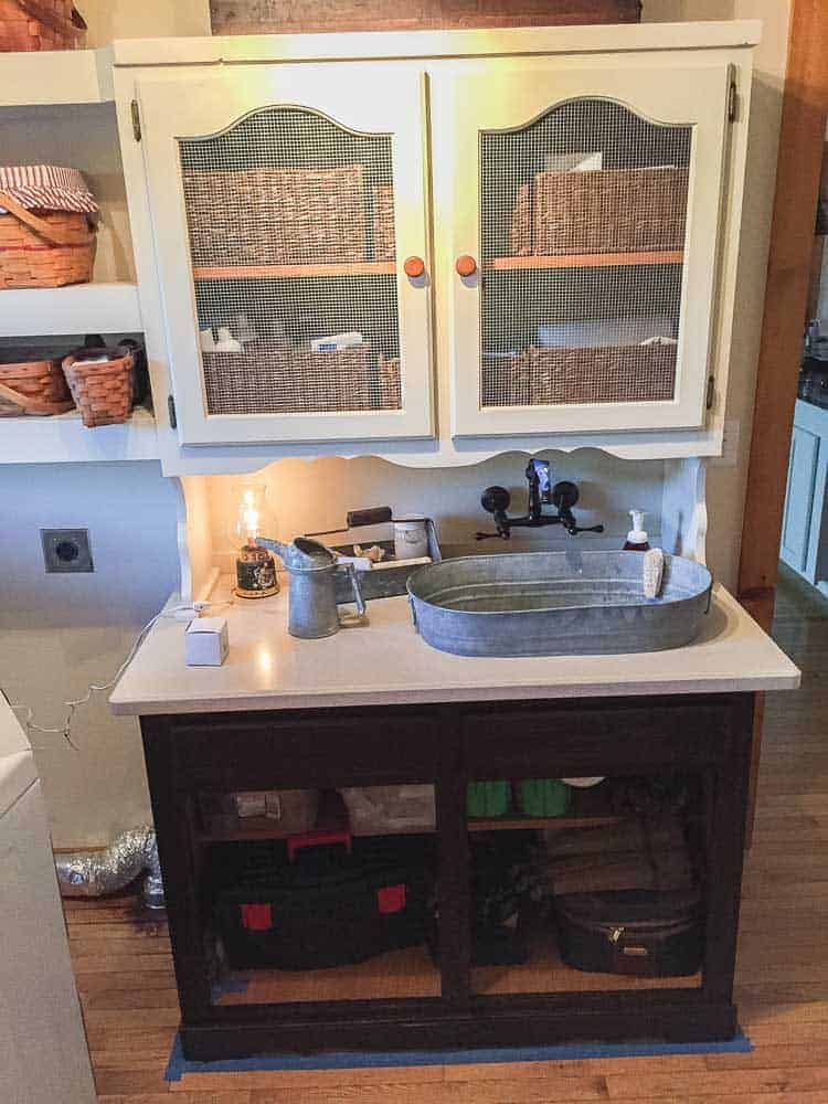 display cabinet repurposed into laundry room storage