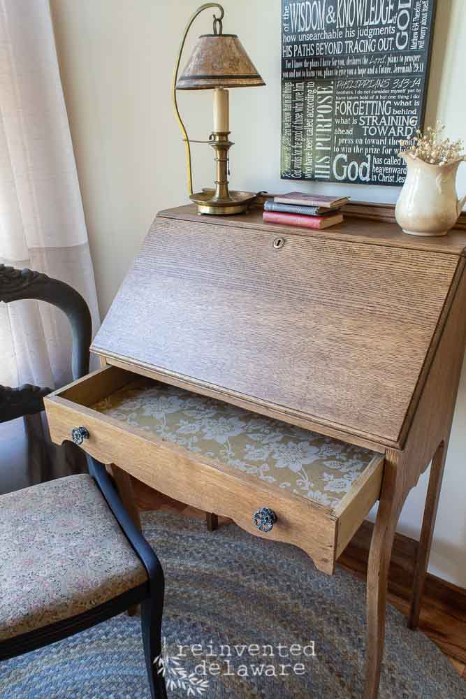 antique oak fold down desk showing interior of lined drawer