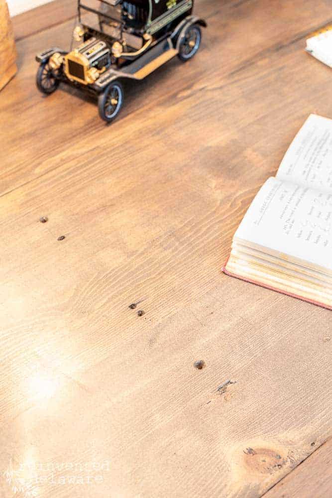 Close up of nail holes in a desk makeover project called Antique Desk Makeover Ideas.