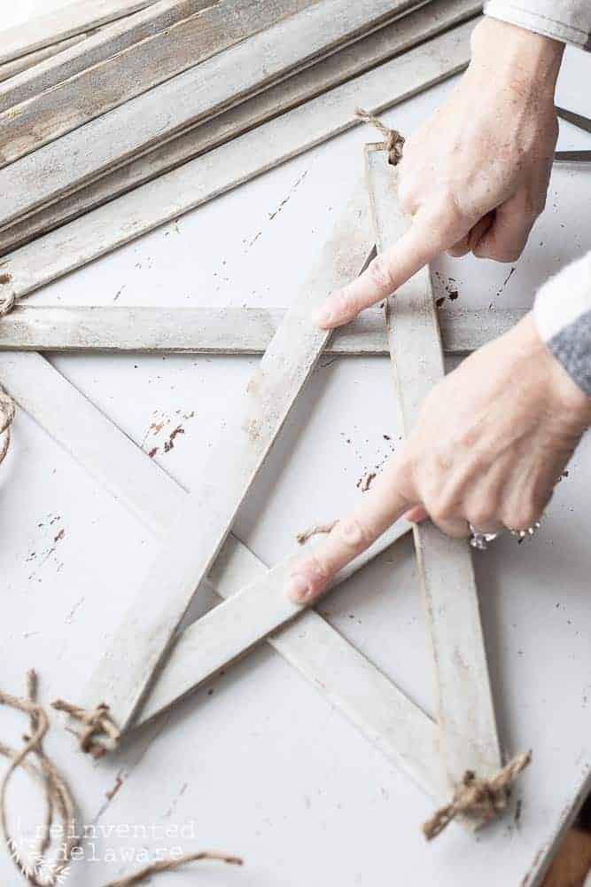 using hot glue to secure intersections of the handmade farmhouse style star