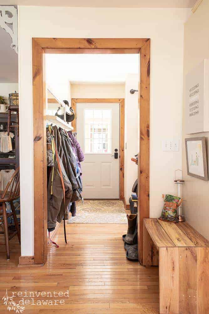 view from kitchen looking through cased opening into laundry room and seeing back door