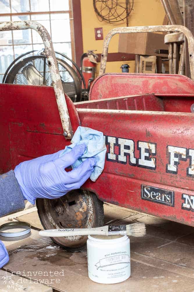 side view of toy firetruck with wax being buffed off