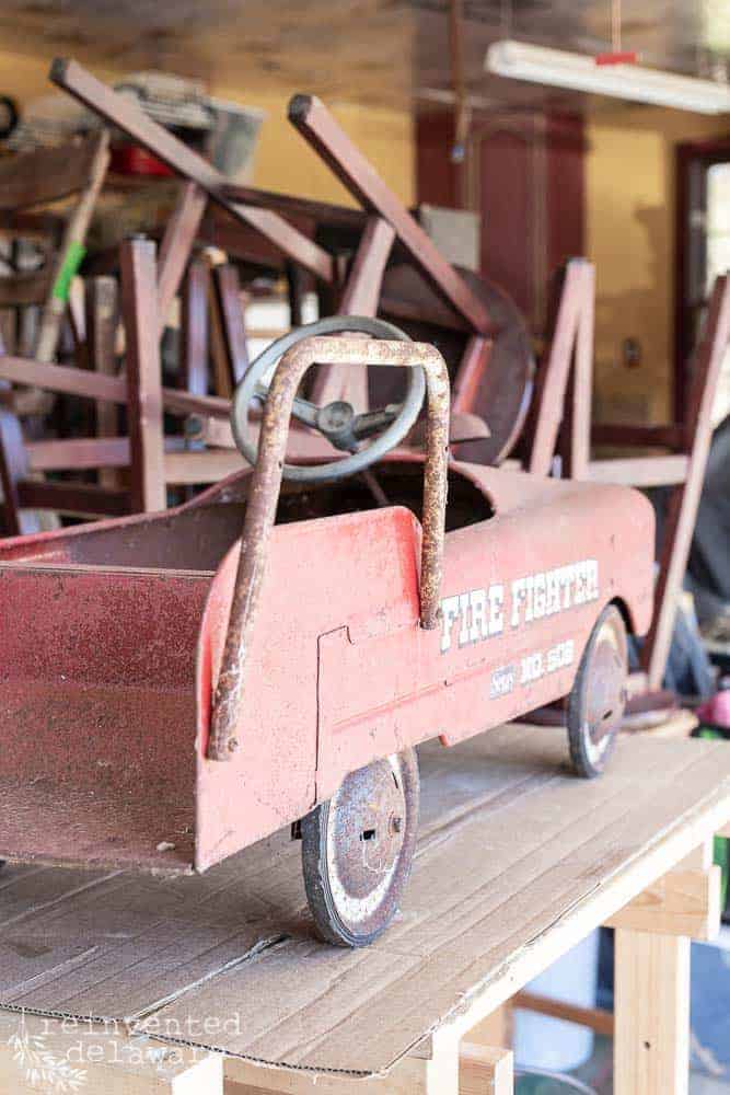 back view of antique toy fire truck showing rust