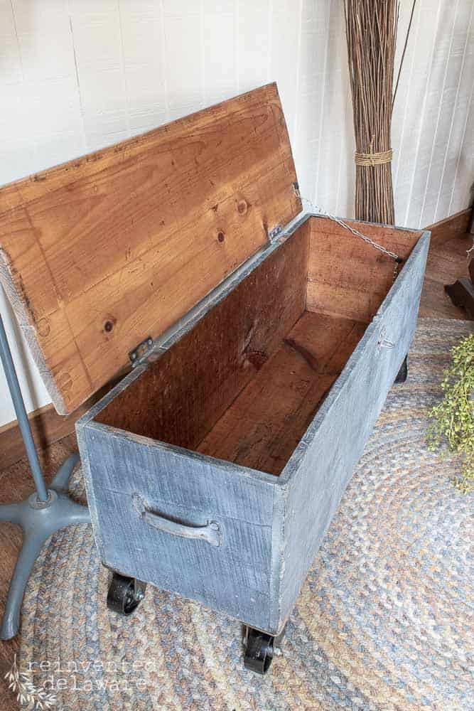 inside of old wooden toolbox showing chain on lid