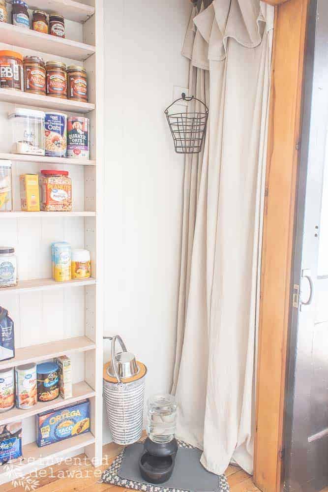 drop cloth curtain hiding a hot water heater in a functional laundry room