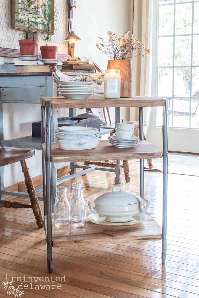 full view of upcycled school cart styled with ironstone dishes and candle