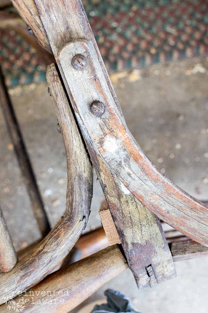 close up of repair made to broken wood bracket on chair