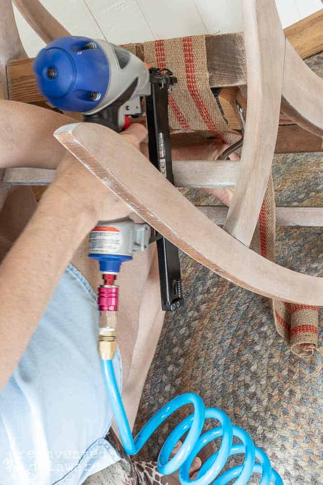 lady using upholstery staple gun to attach upholstery webbing