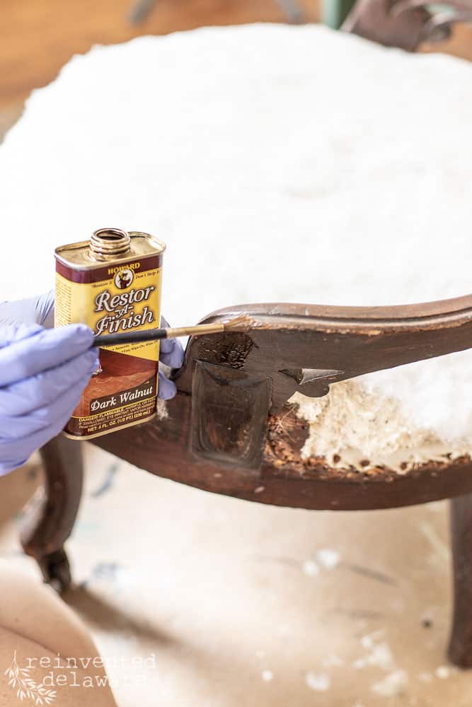 Howards Restor-A-Finish being applied to damaged wood on antique chair