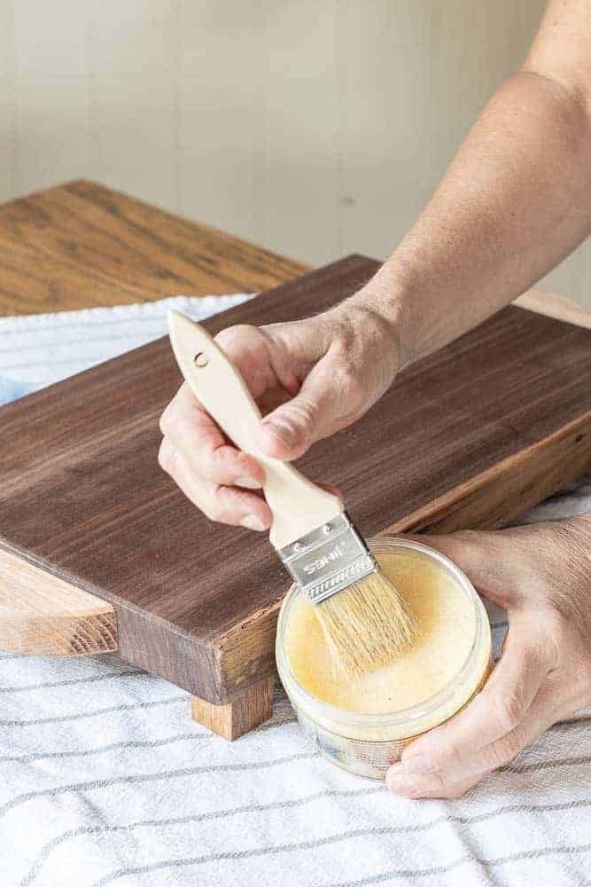 lady showing how to use Howards wax on wood cutting board