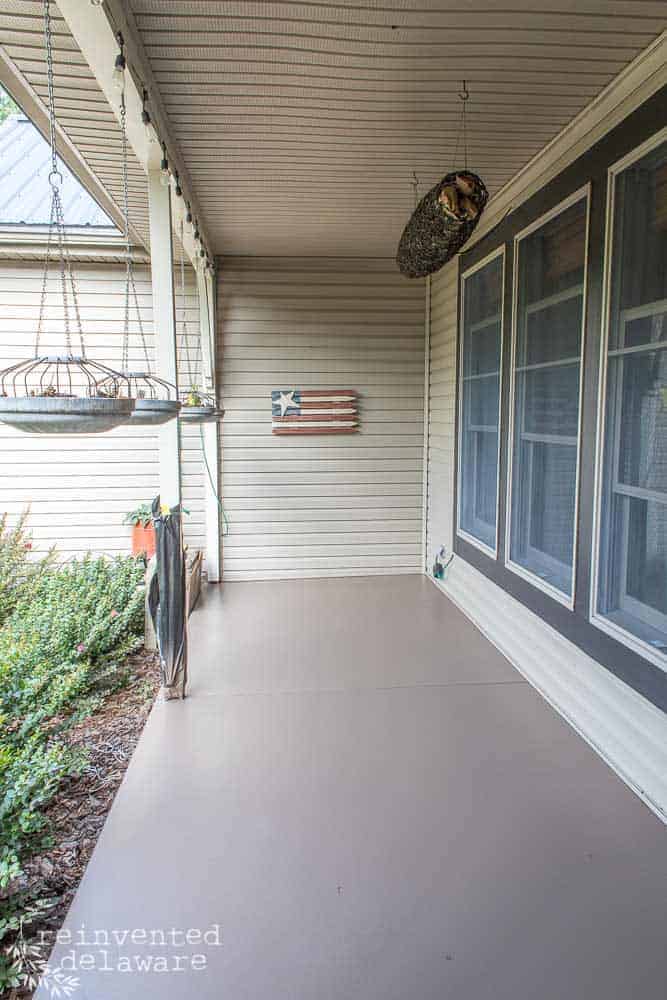 concrete front porch floor after being spray painted with a dark tan paint