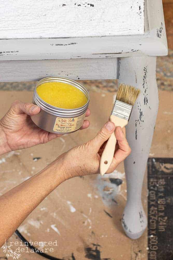 lady applying Dixie Belle Big Mama's Butta to an upcycle wooden tool chest