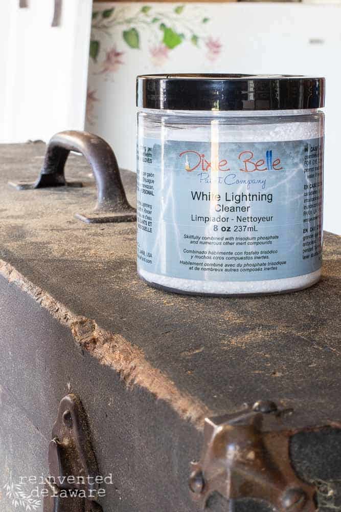 close up shot of Dixie Belle White Lightening Cleaner sitting on top of vintage tool box