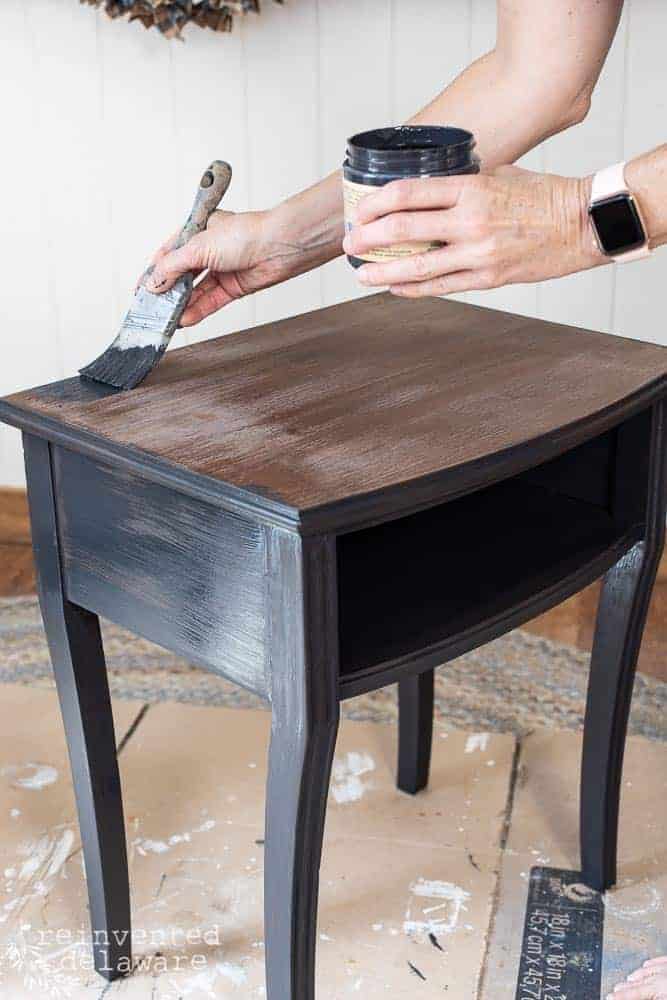 lady painting a small table with Dixie Belle Paint showing an idea of how to paint furniture