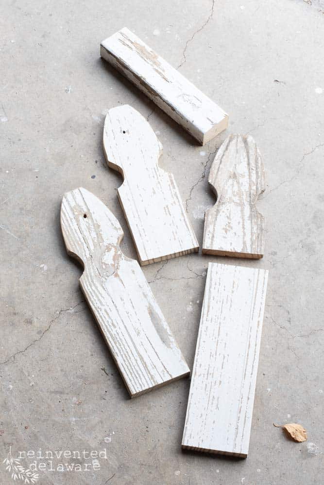 pieces of cut fence boards laying on cement floor of workshop