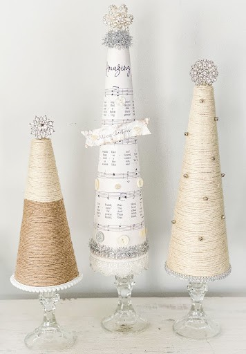 three upcycle candlesticks turned into Christmas tree with cone shape, wrapped in jute twine, book pages and cotton cord