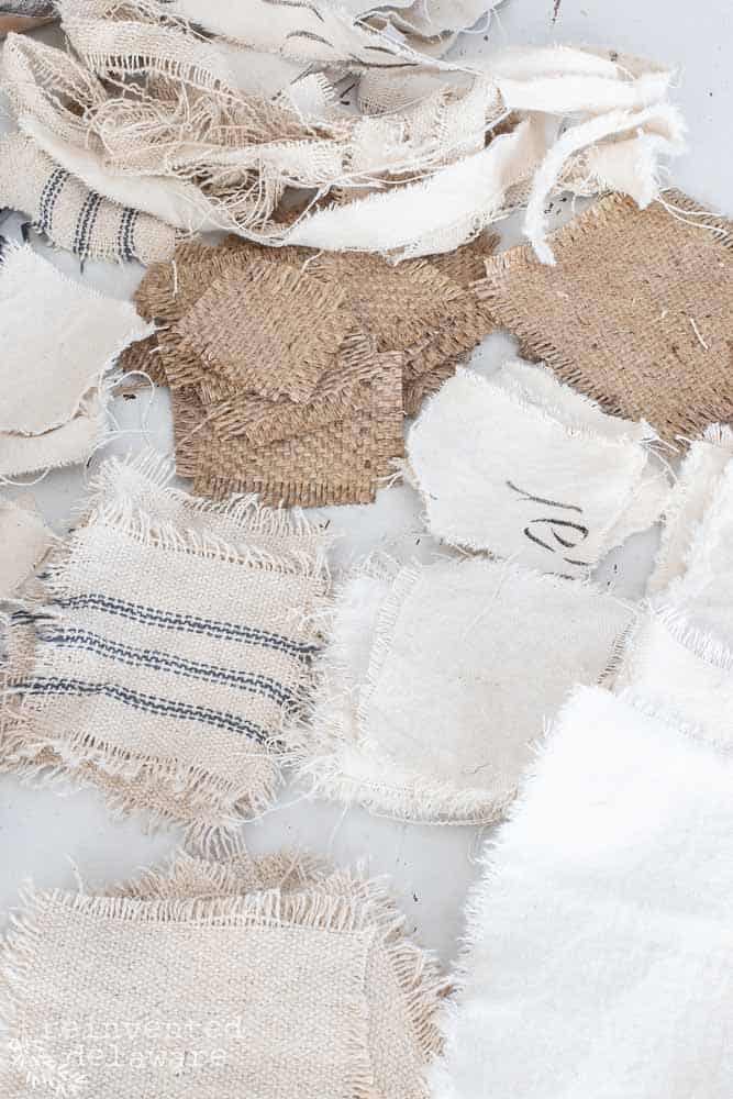 Piles of fabric scrapes in various sizes for a DIY holiday craft for Christmas home decor