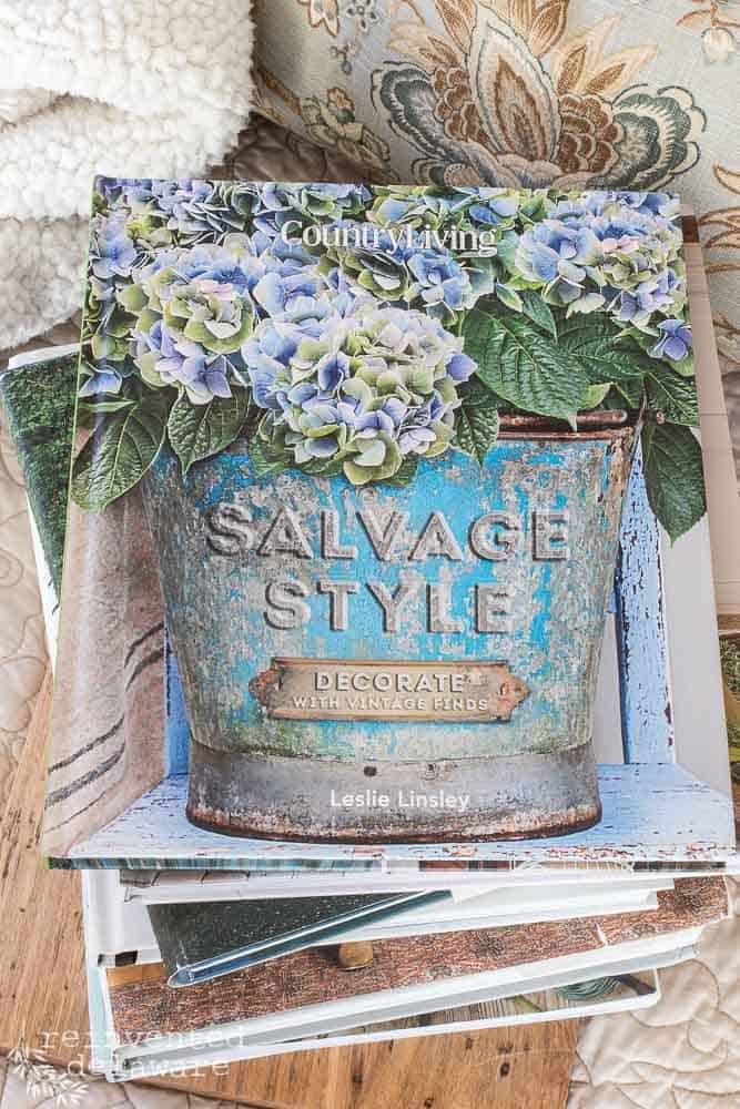 Salvage Style Decorate with Vintage Finds by Leslie Linsley and Country Living book on top of a stack of home decorating ideas books.