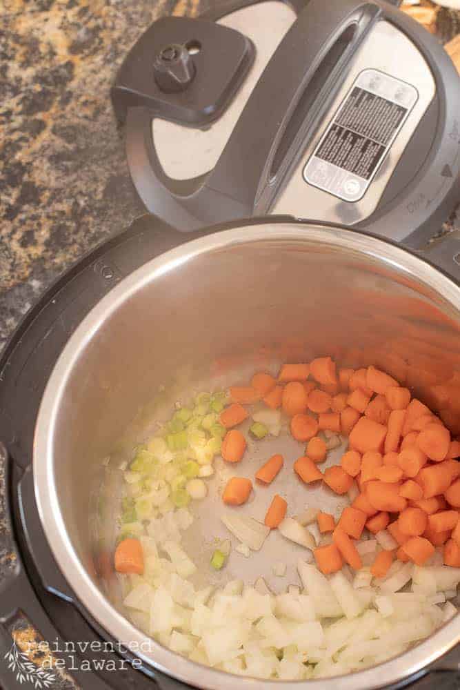 Carrots, onion sauting in the Instant Pot for a shrimp bisque recipe.