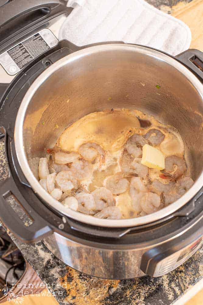 Shrimp cooking in the Intant Pot with butter using the saute feature.