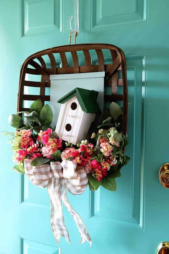Tobacco basket repurposed into a spring themed wreath for a front door.