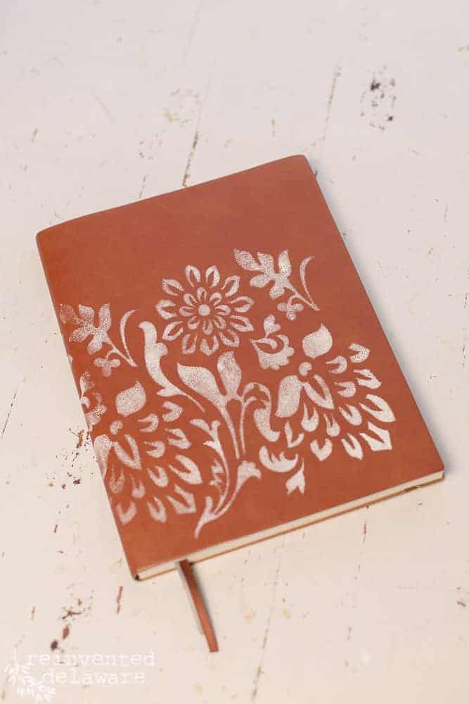 The front of a notebook that was decorated with a stencil and Dixie Belle paint.