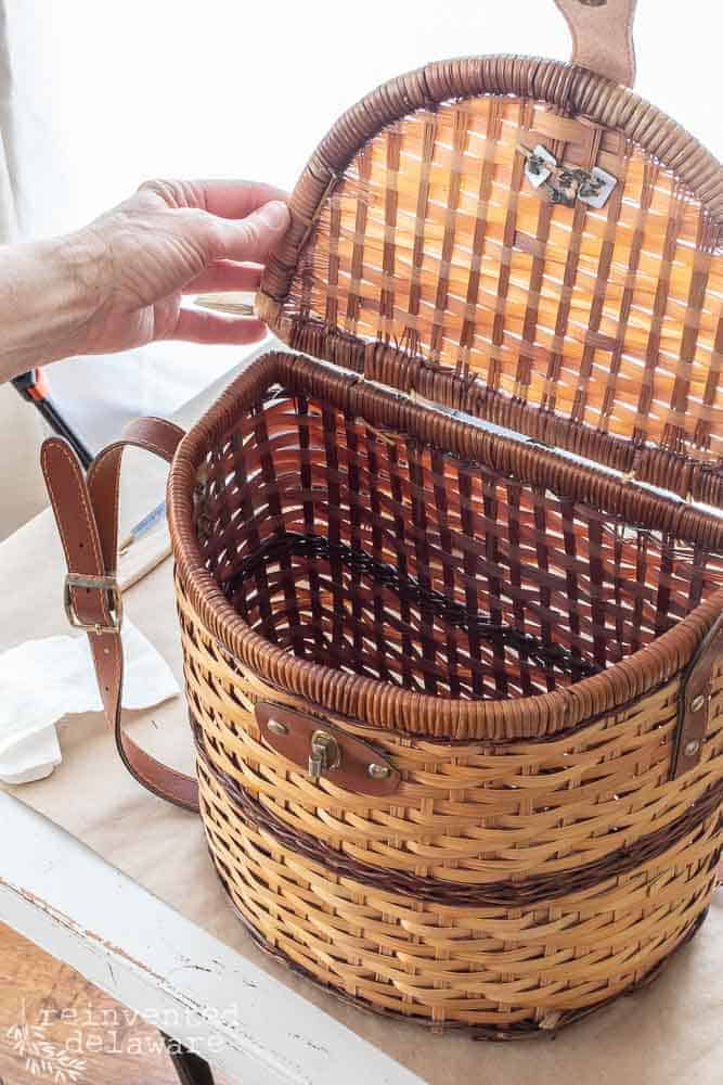Picnic basket with lid open and interior fabric removed to demonstrate a trash to treasure project.