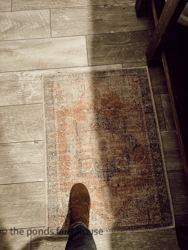 Floor rug on a kitchen floor with someone standing on it.