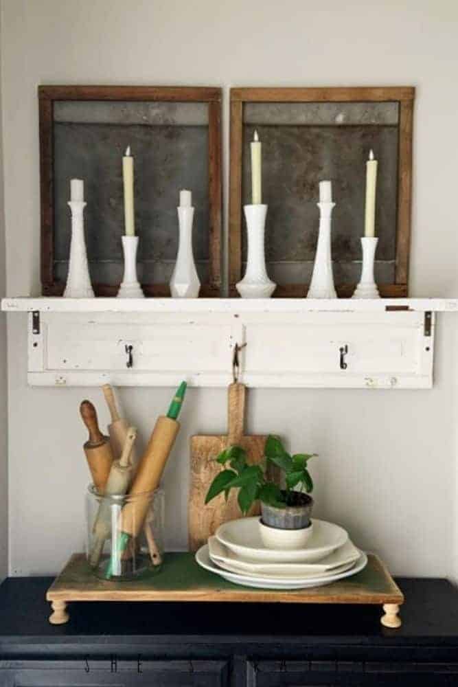 Farmhouse wall decor made from old door. Shelf with candlesticks and other farmhouse home decor.