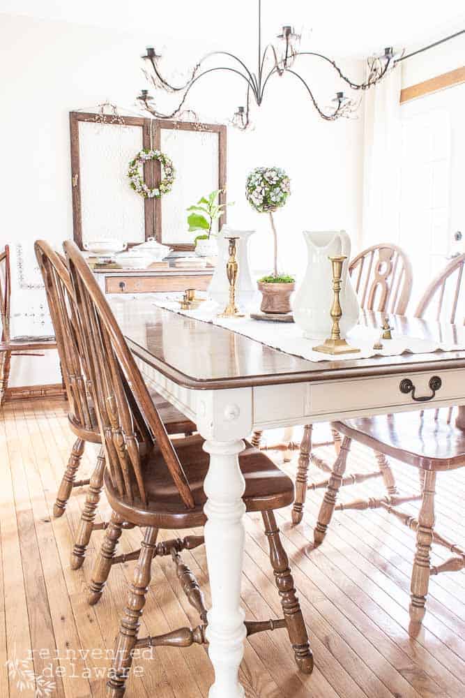 Full view of dining room showing ironstone dishes and other spring home decor.