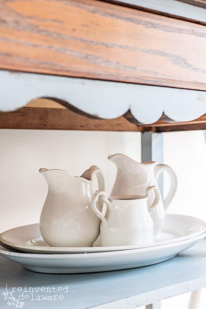 Three ironstone pitchers used in a grouping to show how to decorate with ironstone.