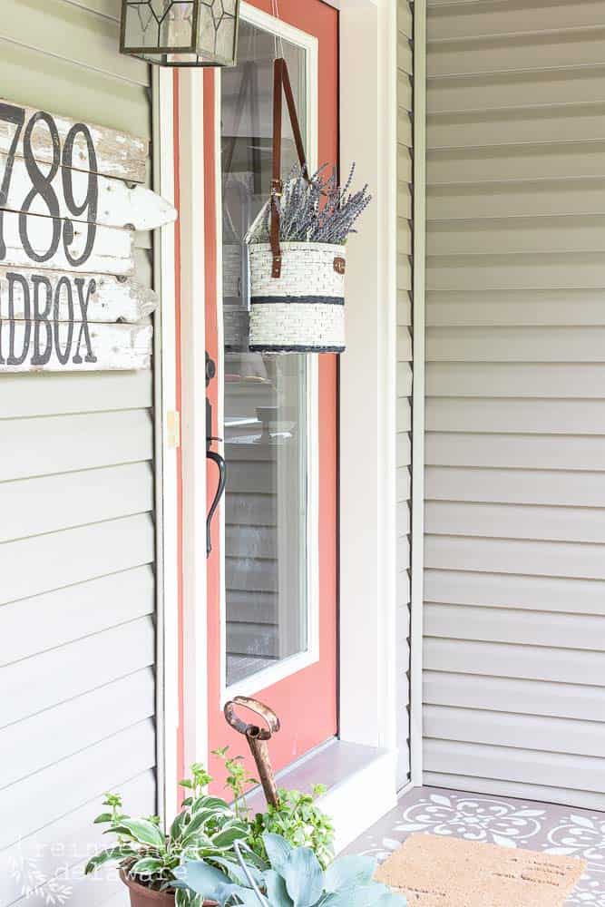 View of front door with basket of lavender hanging on the door.