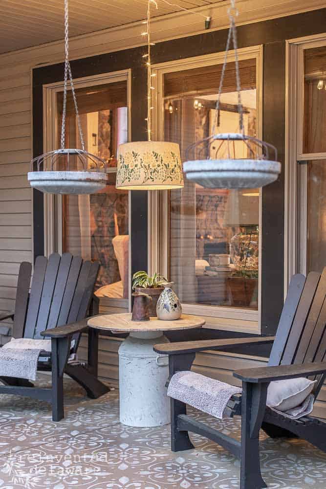 View of front porch with upcycled lampshade hanging over a table.