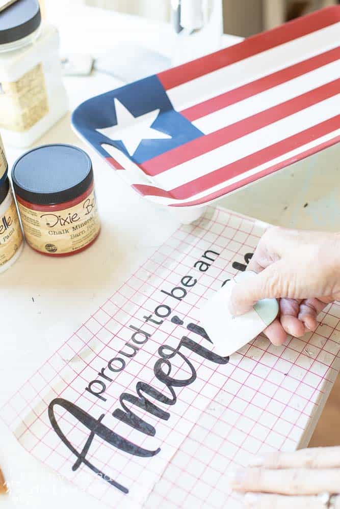 Lady applying Cricut design to a melamine serving tray.