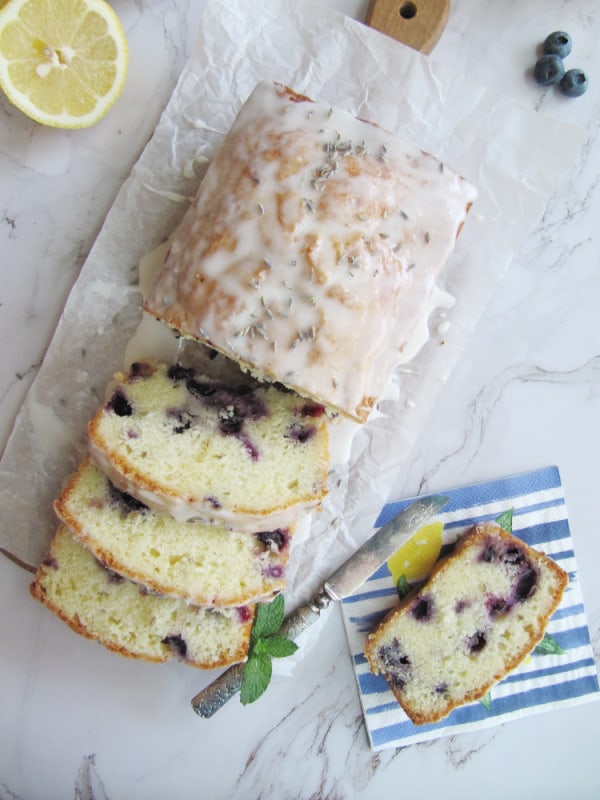 Loaf of homemade blueberry bread with icing.