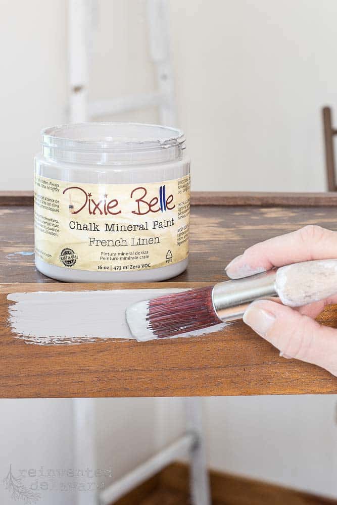 Lady painting diy boho painted furniture with Dixie Belle chalk mineral paint.
