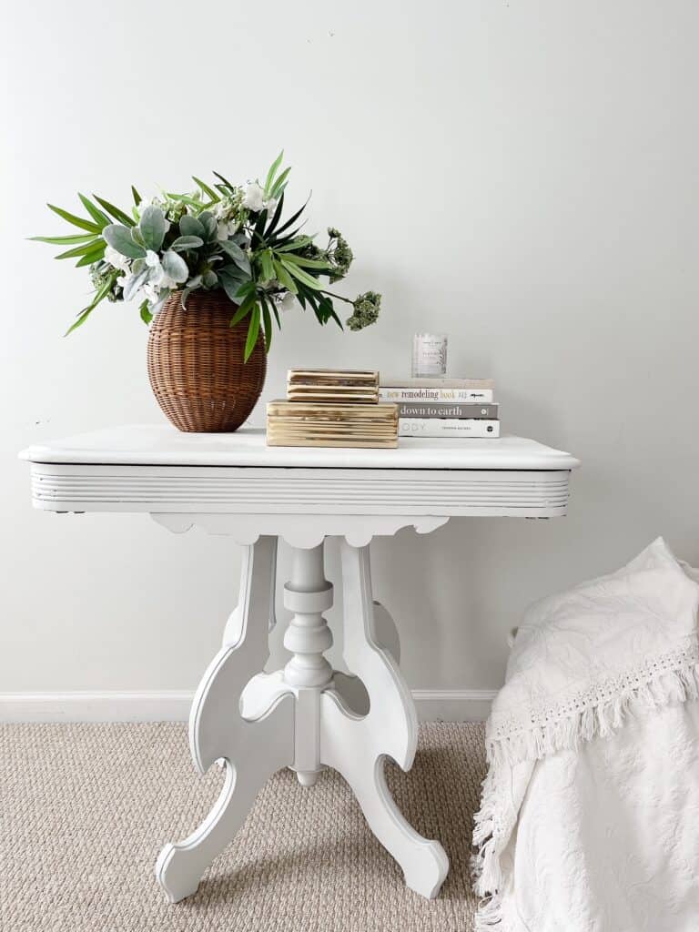 vintage white table with home decor sitting on top