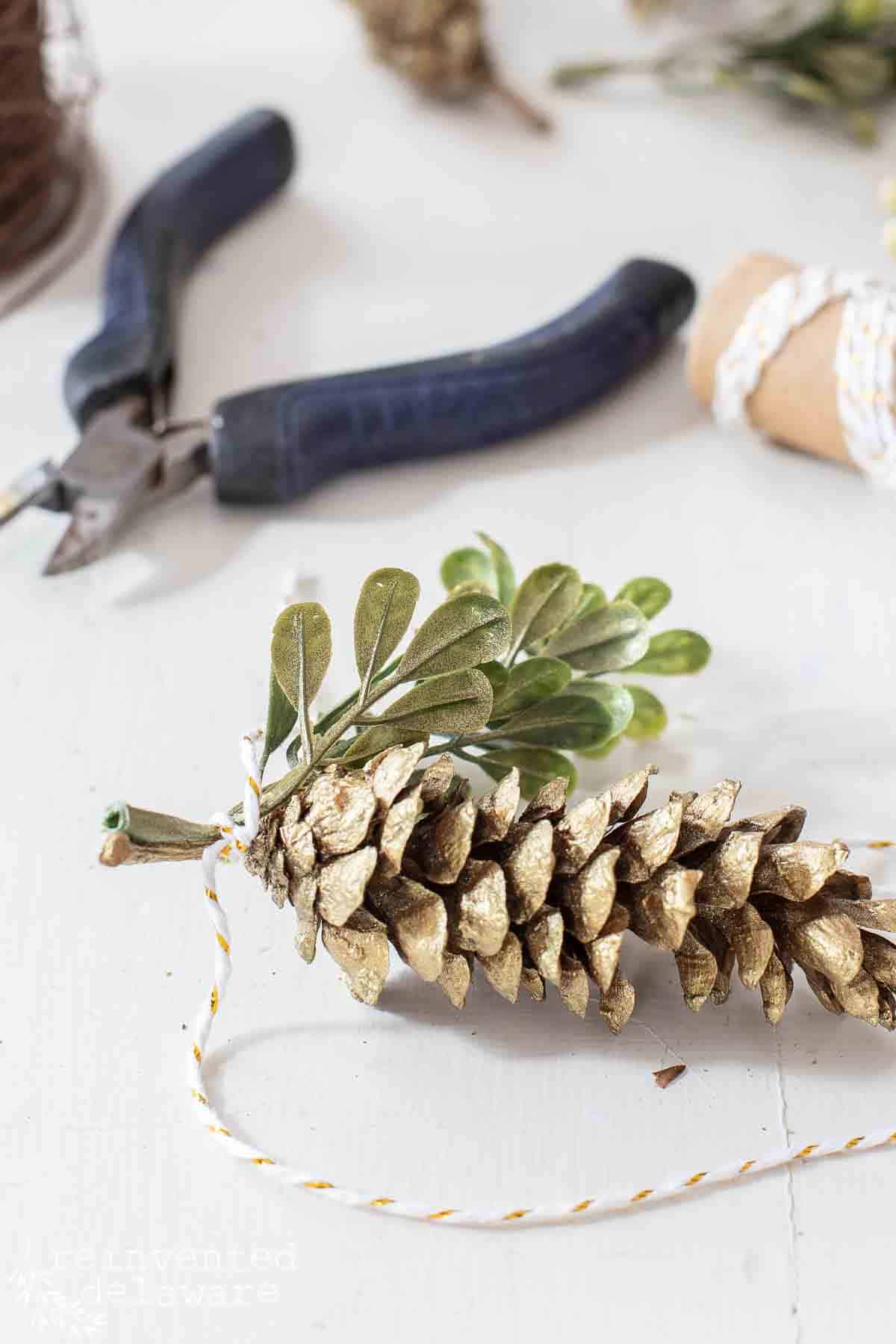 painted pine cone ornament for gift wrapping