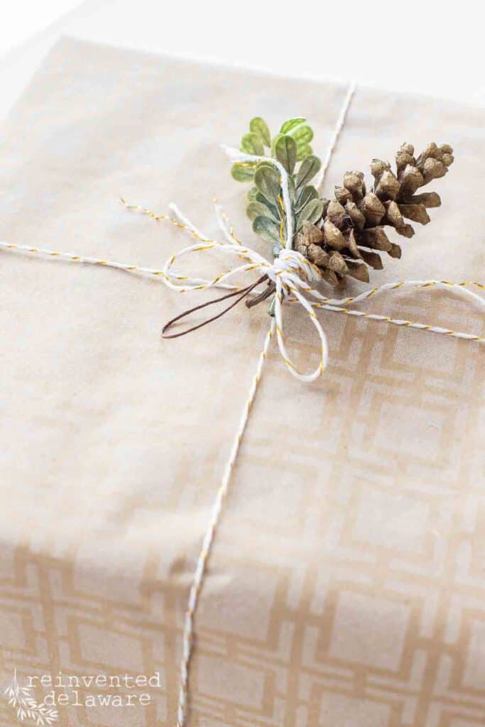 brown craft paper and pine cone ornament for simple gift wrapping ideas