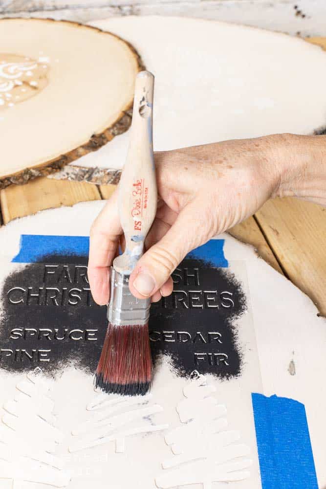 stenciling a wooden sign for diy gift idea for Christmas