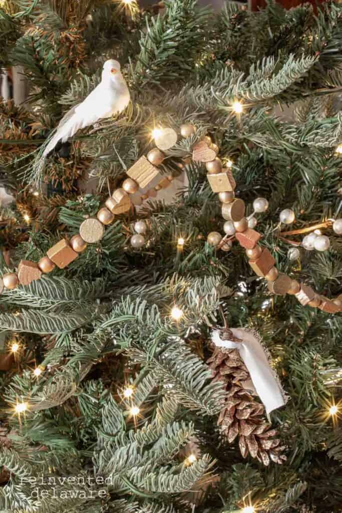 upcycled wooden bead garland on a rustic Christmas tree