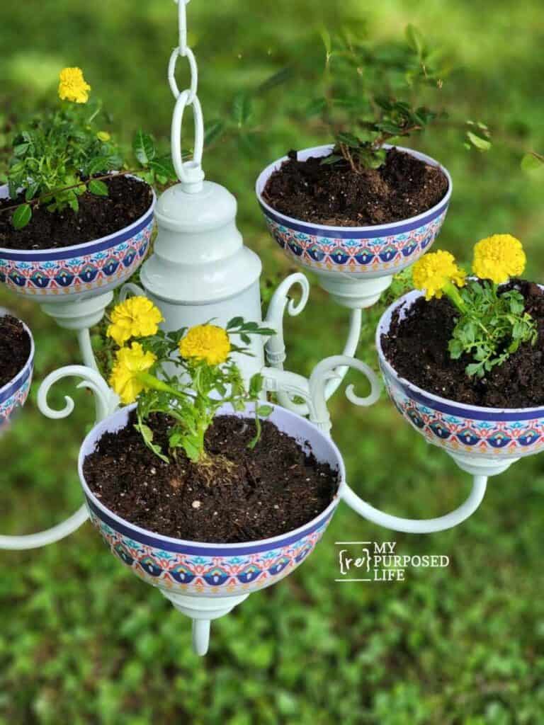 creative ways to use an old chandelier for garden decor as a thrift store upcycled projects