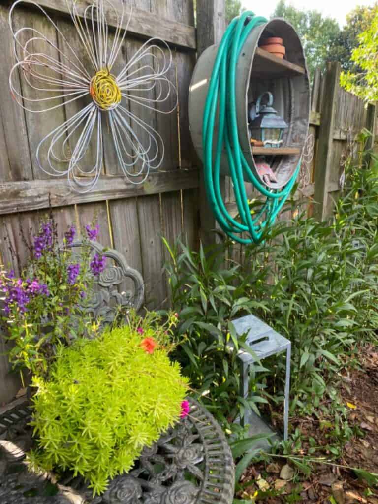 new use for an old galvanized tub as a garden hose holder