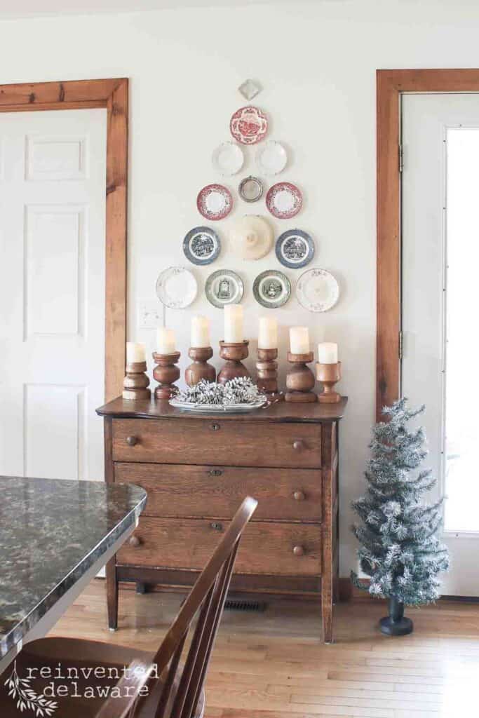 plates hanging on a wall in the shape of a Christmas tree
