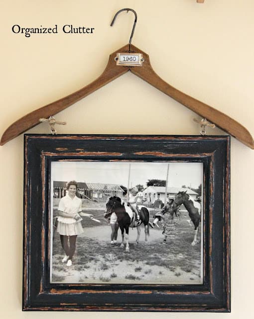 thrift store upcycled project showing a clothes hanger picture frame idea