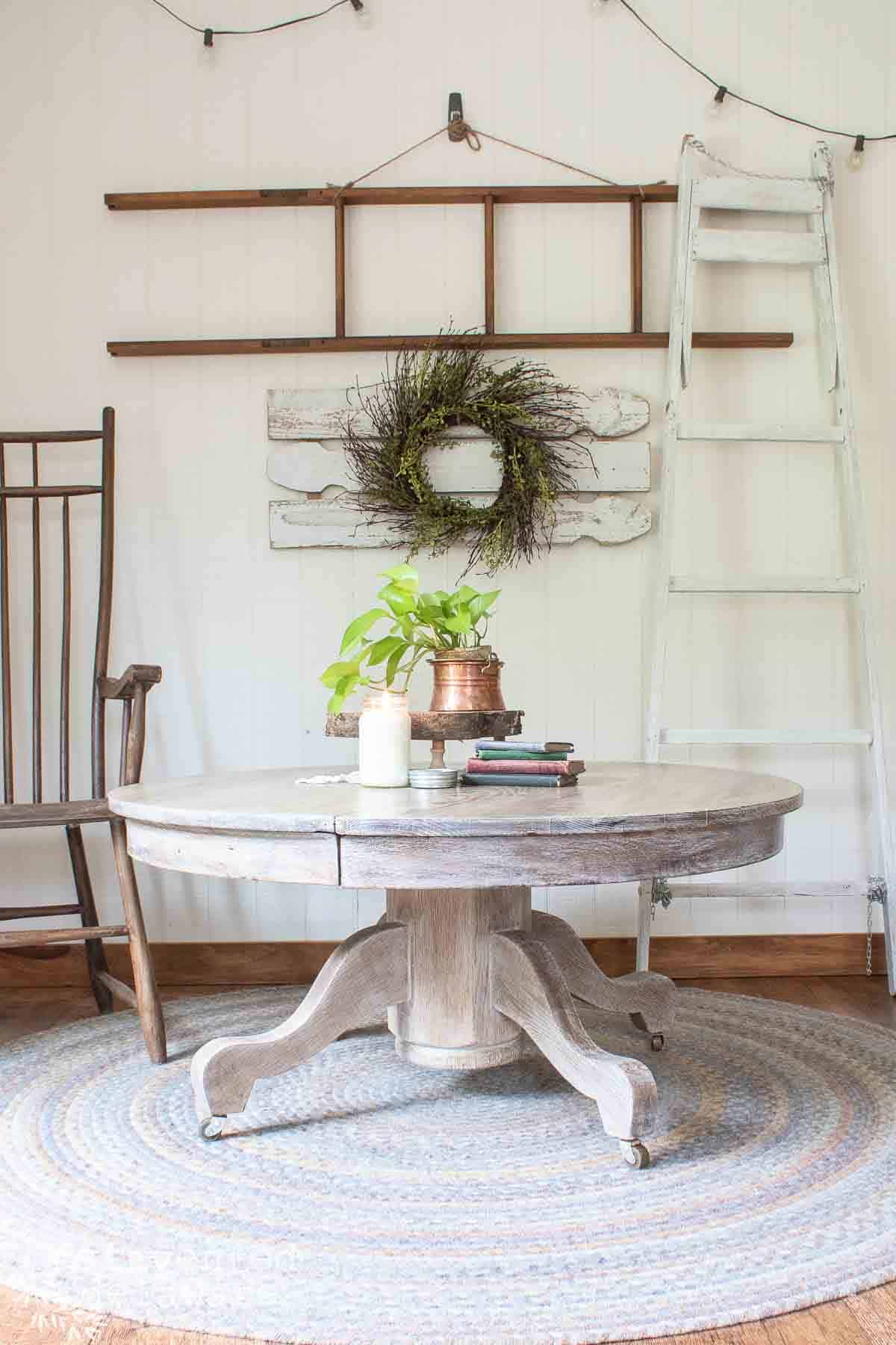 old dining table repurposed into a coffee table with decor